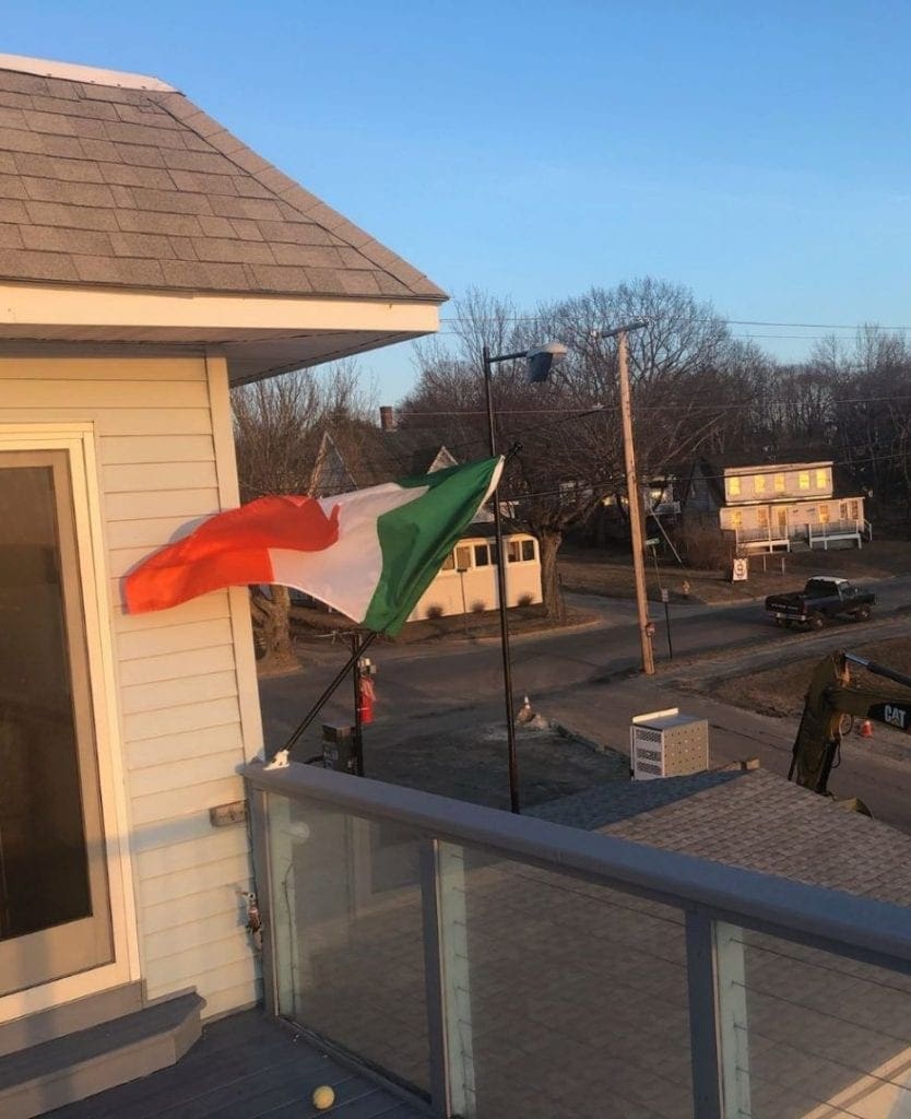 The setting sun lights up the Irish flag at Lionel Plante Associates 